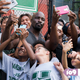 Mike Colter as Luke Cage posing for selfies with a group of neighborhood children.